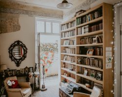 brown fabric sofa chair beside brown bookcase